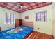 Snug bedroom features colorful patterned ceiling, wood floors, and a themed bed set at 2831 Carolyn Se Dr, Smyrna, GA 30080