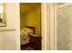 A single bed near a bathroom, nightstand, and wood floors at 2831 Carolyn Se Dr, Smyrna, GA 30080