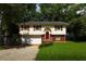 Charming two-story home with red shutters, a well-manicured lawn, and an attached garage at 2831 Carolyn Se Dr, Smyrna, GA 30080