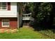Side exterior view of home with brick foundation and access to a backyard deck at 2831 Carolyn Se Dr, Smyrna, GA 30080