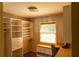 A bright office with desk space, storage, and natural light from a window at 2831 Carolyn Se Dr, Smyrna, GA 30080