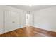 Bright bedroom featuring hardwood floors, white walls, and a closet with double doors at 1240 Woodland Ne Ave # 7, Atlanta, GA 30324