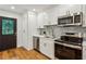 Kitchen with stainless steel appliances, white cabinets, stylish hardware and eat-in bar at 1240 Woodland Ne Ave # 7, Atlanta, GA 30324