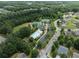 Aerial view of neighborhood amenities including the community pool, tennis courts, and surrounding trees at 1722 Preserve Creek Way, Loganville, GA 30052