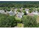 Aerial view showcasing the home's location within a neighborhood surrounded by lush trees at 1722 Preserve Creek Way, Loganville, GA 30052