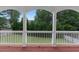 This is a close up of the beautiful wooden balcony with railing overlooking the backyard at 1722 Preserve Creek Way, Loganville, GA 30052