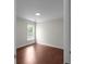 This is a bedroom with wood floors and a window at 1722 Preserve Creek Way, Loganville, GA 30052