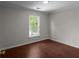 Bedroom features hardwood flooring and a bright window at 1722 Preserve Creek Way, Loganville, GA 30052