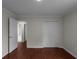 Bedroom featuring wood floors, closet, and entrance to ensuite bathroom at 1722 Preserve Creek Way, Loganville, GA 30052