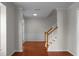 Elegant foyer showcasing hardwood floors, wainscoting, and a staircase with wood railings at 1722 Preserve Creek Way, Loganville, GA 30052