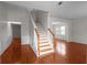 Elegant foyer showcasing hardwood floors, wainscoting, and a staircase with wood railings at 1722 Preserve Creek Way, Loganville, GA 30052