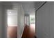 Inviting hallway with wood-look flooring leads to bright, naturally lit rooms at 1722 Preserve Creek Way, Loganville, GA 30052