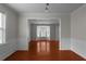 Open living room with hardwood floors, wainscoting, and bay windows at 1722 Preserve Creek Way, Loganville, GA 30052
