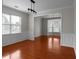 Bright living room with beautiful hardwood floors, wainscoting, and large windows at 1722 Preserve Creek Way, Loganville, GA 30052
