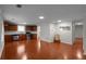 Open-concept living room flows into the kitchen, boasting hardwood floors and ample natural light at 1722 Preserve Creek Way, Loganville, GA 30052