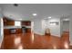Open-concept living room flows into the kitchen, boasting hardwood floors and ample natural light at 1722 Preserve Creek Way, Loganville, GA 30052