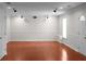 Well-lit living room featuring wood floors, white trim, and recessed lighting, perfect for entertaining at 1722 Preserve Creek Way, Loganville, GA 30052