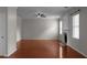Open living room featuring a fireplace, two windows and hardwood floors at 1722 Preserve Creek Way, Loganville, GA 30052