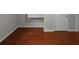 Small room with hardwood floors and door at 1722 Preserve Creek Way, Loganville, GA 30052