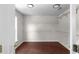 Large walk-in closet with wood-look floors, shelving, and hanging rods at 1722 Preserve Creek Way, Loganville, GA 30052