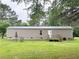 Home exterior with a deck, backyard, and green lawn at 2567 Hancock Rd, Social Circle, GA 30025