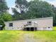 Backyard of home with a green lawn and mature shade trees at 2567 Hancock Rd, Social Circle, GA 30025
