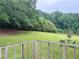 Overlooking a spacious and serene backyard from a wooden deck, perfect for outdoor gatherings at 2567 Hancock Rd, Social Circle, GA 30025
