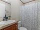 Bathroom with vanity sink and shower with blue floral shower curtain at 2567 Hancock Rd, Social Circle, GA 30025