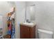 Cozy bathroom showcasing a single vanity, mirror, toilet, and convenient closet storage at 2567 Hancock Rd, Social Circle, GA 30025