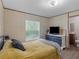 Comfortable bedroom with a window, TV, and bathroom access at 2567 Hancock Rd, Social Circle, GA 30025