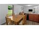Eat-in kitchen featuring a wood dining table with seating, and view into living room at 2567 Hancock Rd, Social Circle, GA 30025