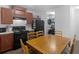 Eat-in kitchen featuring dark cabinets, modern appliances, and adjacent laundry area at 2567 Hancock Rd, Social Circle, GA 30025