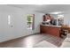 Bright living room featuring wood-look floors, a window, and an eat-in kitchen at 2567 Hancock Rd, Social Circle, GA 30025