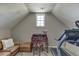 Finished attic space with desk, treadmill, and natural light from window at 4171 Lantern Hill Dr, Dacula, GA 30019