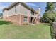 Exterior view of a backyard showcasing the house, green lawn, and wooded surroundings at 4171 Lantern Hill Dr, Dacula, GA 30019