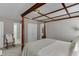 Bedroom with four-poster bed frame, double door closet, and neutral decor at 4171 Lantern Hill Dr, Dacula, GA 30019
