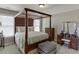 Bedroom featuring four-poster bed, and matching vanity with a three pane mirror at 4171 Lantern Hill Dr, Dacula, GA 30019