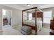 Bedroom with detailed four-poster bed frame and neutral color palette at 4171 Lantern Hill Dr, Dacula, GA 30019