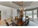Elegant dining room with paneled walls, a decorative chandelier, and a view to the front door at 4171 Lantern Hill Dr, Dacula, GA 30019