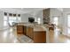Open concept kitchen with granite countertops, breakfast bar, and hardwood floors at 4171 Lantern Hill Dr, Dacula, GA 30019