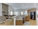 Spacious kitchen with granite counters, stainless appliances, and adjacent living space at 4171 Lantern Hill Dr, Dacula, GA 30019
