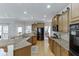 Open kitchen with granite counters, stainless appliances, and hardwood floors at 4171 Lantern Hill Dr, Dacula, GA 30019