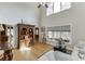 Bright living room featuring tall ceilings, large windows, and beautiful hardwood flooring at 4171 Lantern Hill Dr, Dacula, GA 30019