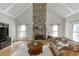 Inviting living room features a stone fireplace, wood floors, and comfortable seating at 4171 Lantern Hill Dr, Dacula, GA 30019