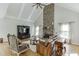 Inviting living room with a floor-to-ceiling stone fireplace, vaulted ceiling, and hardwood floors at 4171 Lantern Hill Dr, Dacula, GA 30019