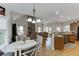 Open concept living space with vaulted ceilings, stone fireplace, and seamless flow to the kitchen at 4171 Lantern Hill Dr, Dacula, GA 30019