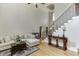 Bright living room with a vaulted ceiling, staircase, and comfortable sofa at 4171 Lantern Hill Dr, Dacula, GA 30019