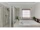 Main bathroom featuring a soaking tub with jets and a separate glass shower at 4171 Lantern Hill Dr, Dacula, GA 30019