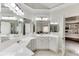 Main bathroom showcasing a vanity with double sinks, mirrors, and ample counter space at 4171 Lantern Hill Dr, Dacula, GA 30019