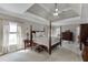 Large main bedroom with tray ceiling, ceiling fan, and furniture throughout at 4171 Lantern Hill Dr, Dacula, GA 30019
